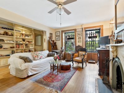 A living room with hard wood floors and furniture.