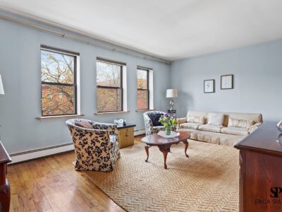 A living room with hard wood floors and furniture.