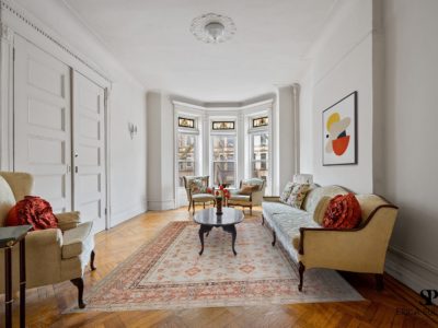 A living room with white walls and wooden floors.