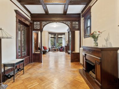 A large hallway with wooden floors and fireplace.