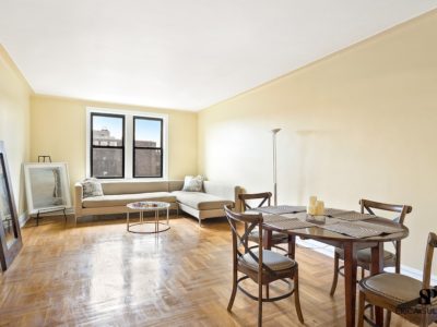 A living room with a couch, table and chairs.