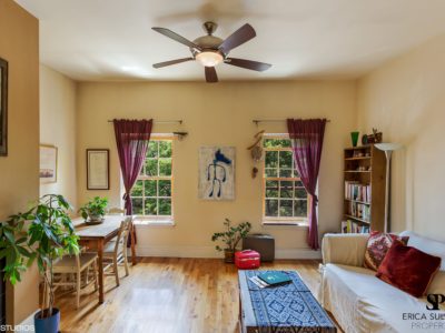 A living room with a couch, table and chair.