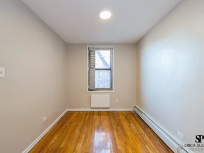 A room with hard wood floors and white walls.