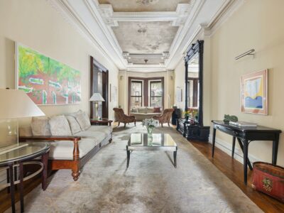 A living room with a couch, table and chairs.