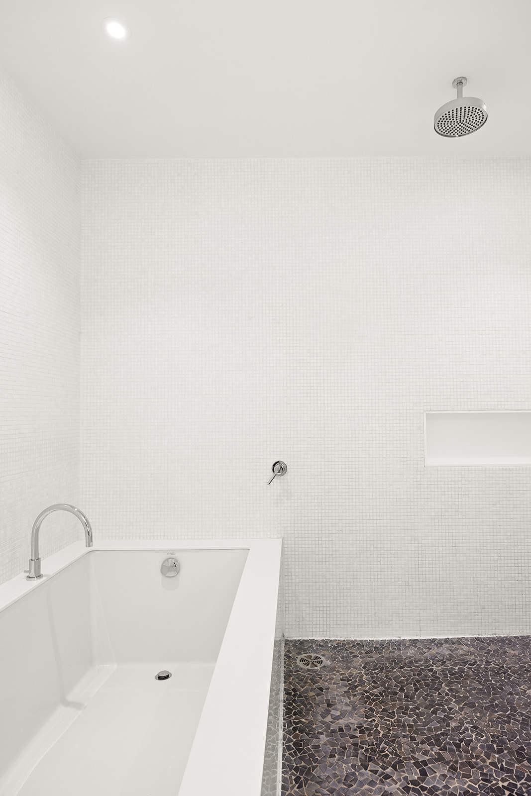 A white bath tub sitting in the middle of a bathroom.