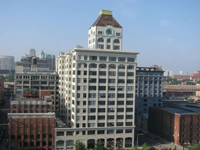 A large building with a clock tower in the center of it.