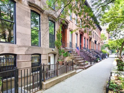 A row of houses on the side of a street.