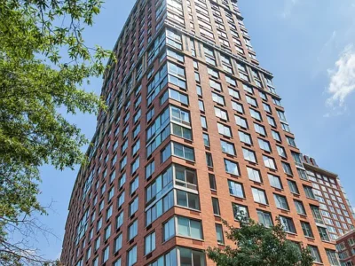 A tall building with many windows and trees